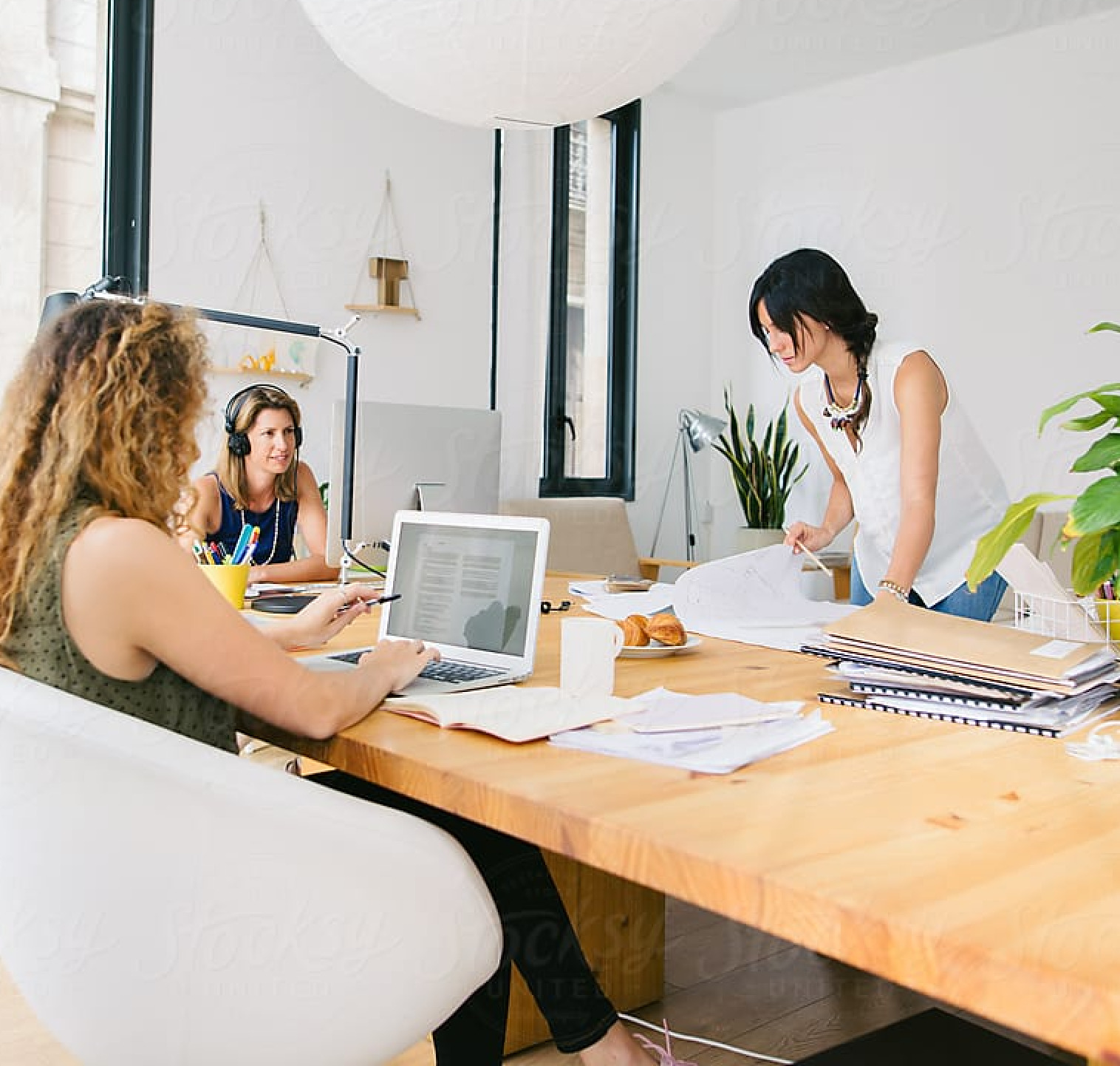 Three people in a work meeting