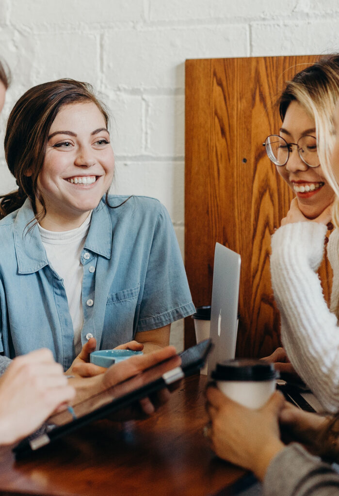 Two women smiling at a cafe table