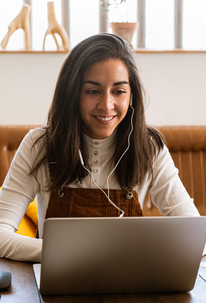 Woman using a laptop with headphones