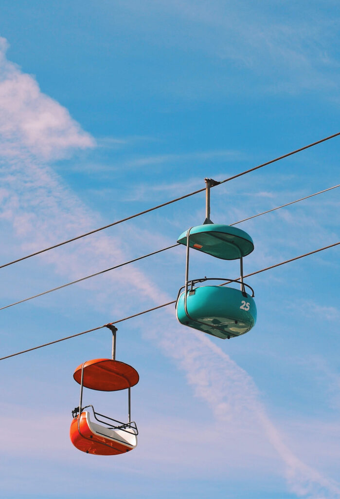 Colorful cable cars with a blue sky in the background