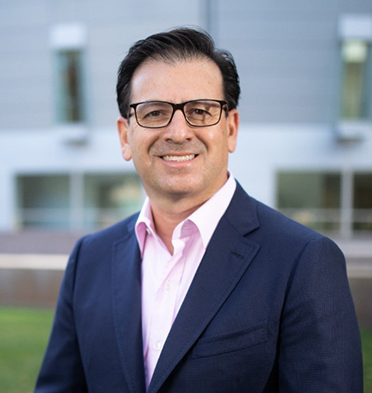 Smiling man wearing a suit and glasses